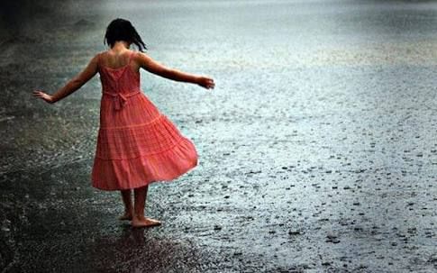 A girl thanking rain gods