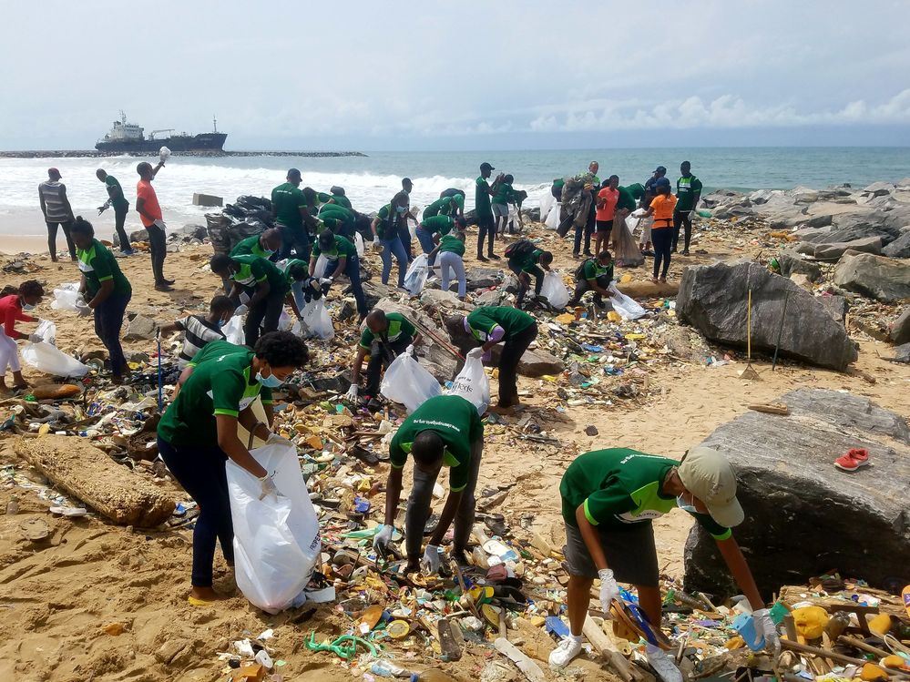 Caption: A photo of people cleaning up a beach in Nigeria. (Courtesy of Local Guide @EmekaUlor)