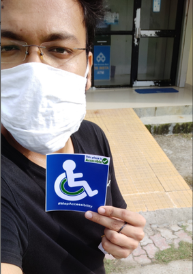 Selfie with wheelchair accessible sticker infront of a ramp