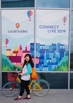 Caption: A photo of Feliciana posing with a Google bicycle during Connect Live 2019.