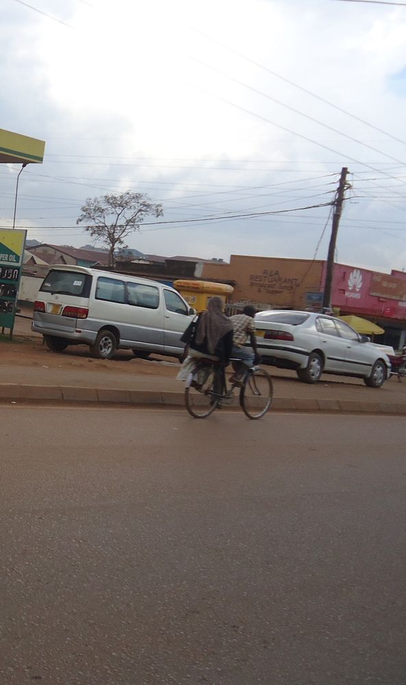Another woman on a bicycle boda boda.
