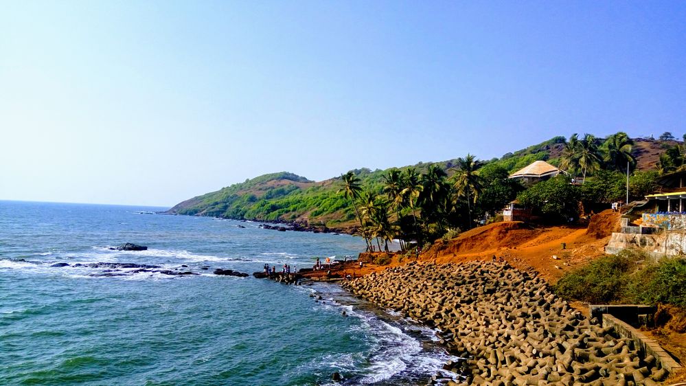 Place : Goa, India. The picture shows that the place is not much crowded and beach is surrounded with greenery views. This beach is one of the peaceful beach in North Goa. Usually people visit here for sunset view.