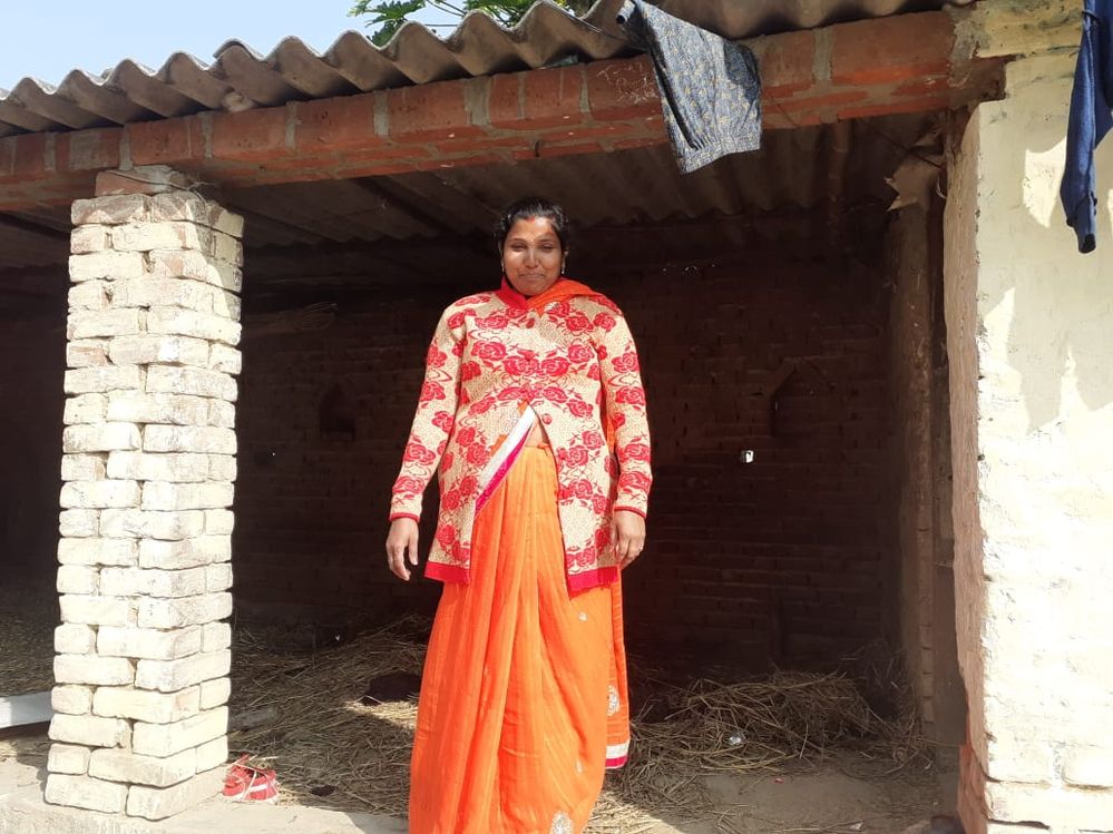 Sheela near her cowshed. To her left is her shop!
