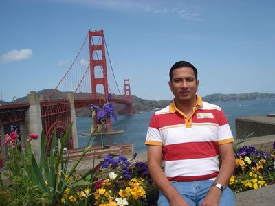 Caption: A photo of Tushar in front of the Golden Gate bridge.
