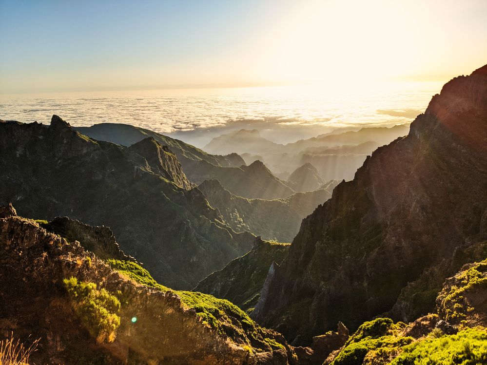 Caption: A photo of sunlight washing over mountains and a sea of clouds as seen from Pico Arieiro in Madeira, Portugal. (Local Guide @StephenLammens)