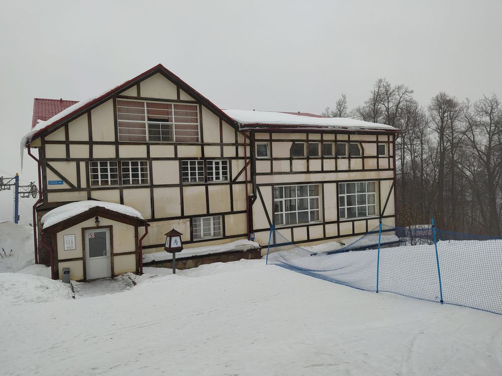 Caption: A German architecture style sport complex. The front ground is covered in snow.