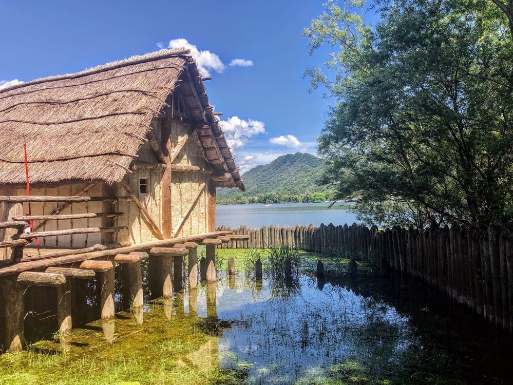 Caption: A photo of a Neolithic house on stilts at Parco Archeologico Didattico Livelet in Italy. (Local Guide @davidhyno)