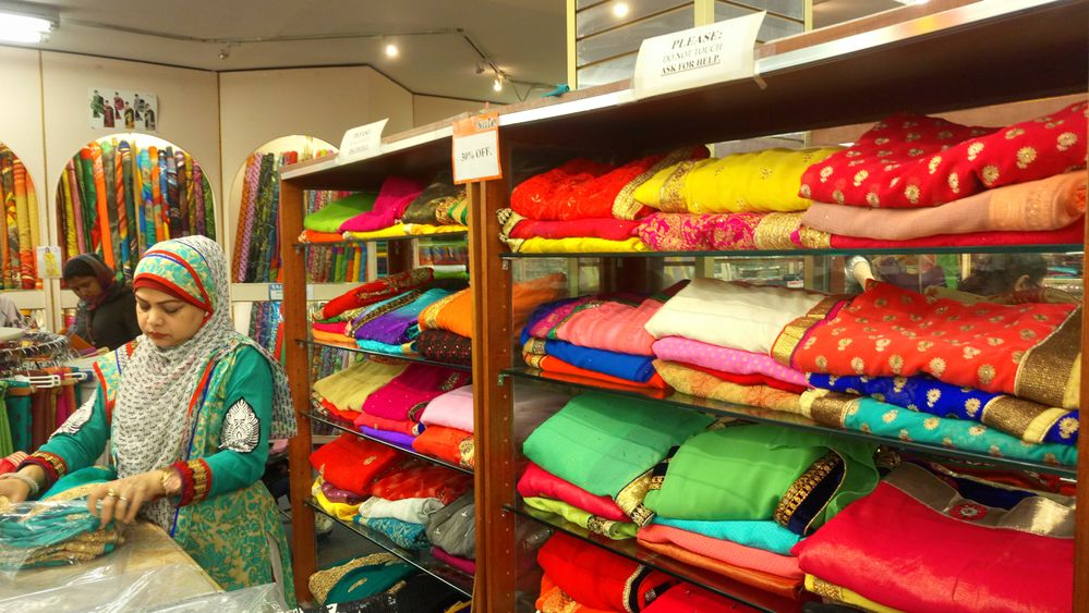 Caption: A photo of assorted folded saris on a display shelf at India Sari Palace in Jackson Heights. (Local Guide Cristina D’Ortona)