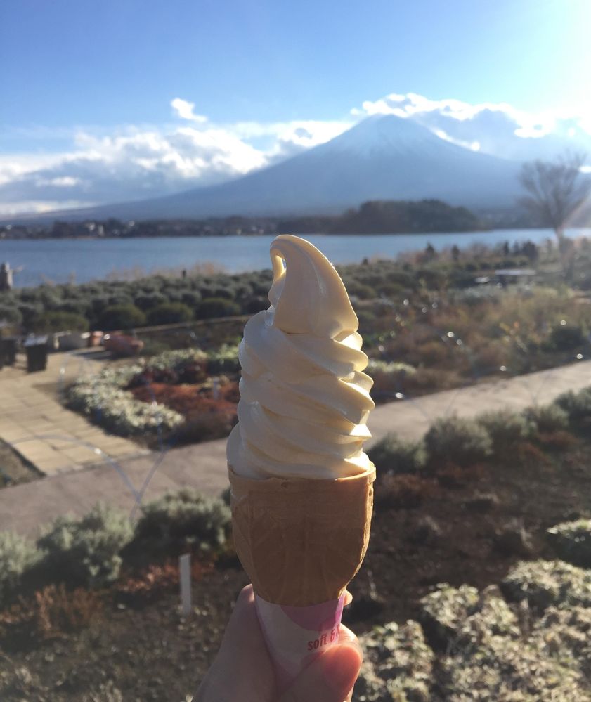 Caption: A photo of vanilla soft ice cream on a cone being held with Mount Fuji on the background (Local Guide @AngieYC)