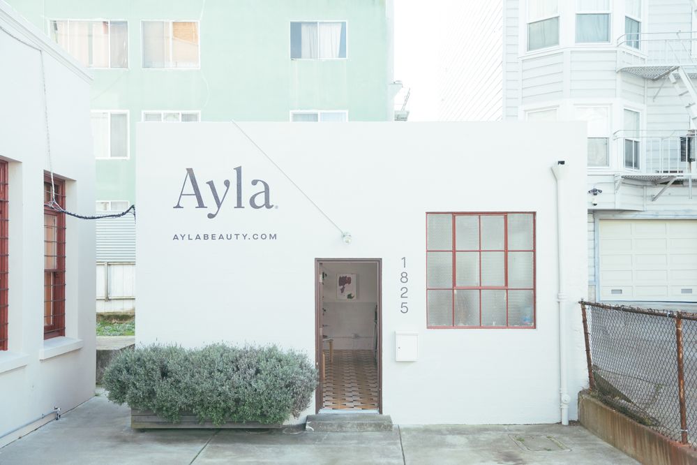 Caption: A photo of the outside of the Ayla Beauty storefront.