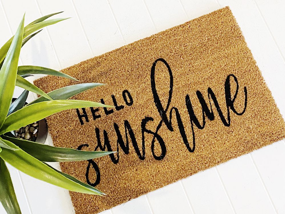 Caption: A photo of a doormat that says “Hello Sunshine” on display at Bliss Gifts & Homewares.