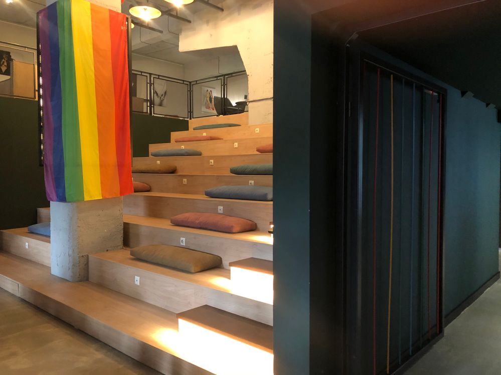 Caption: A photo of the stairs leading to the second floor of The Steps bar with the rainbow flag on the left. (Local Guide @Bobiisha)