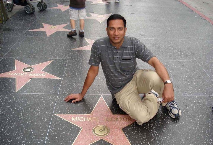 Caption: A photo of Tushar sitting on the Hollywood Walk of Fame next to Michael Jackson’s star. (Courtesy of Local Guide @Tushar_Suradkar)
