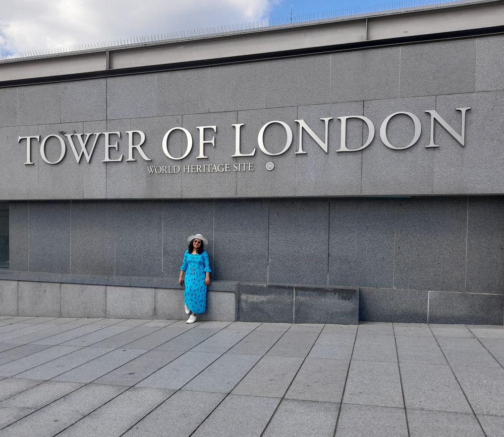 Caption: A photo of Isha in front of a wall with the lettering, “Tower of London, World Heritage Site.” (Courtesy of Local Guide @Globe_trotter_Isha)