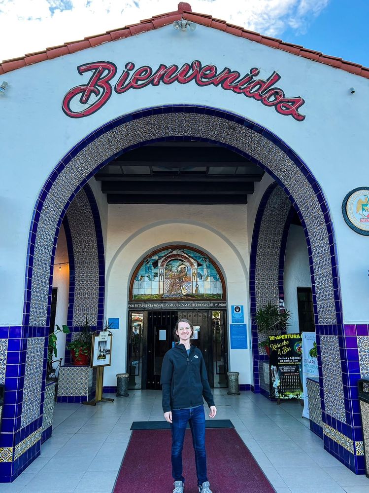 my partner standing at the Rosarito Beach Hotel entrance