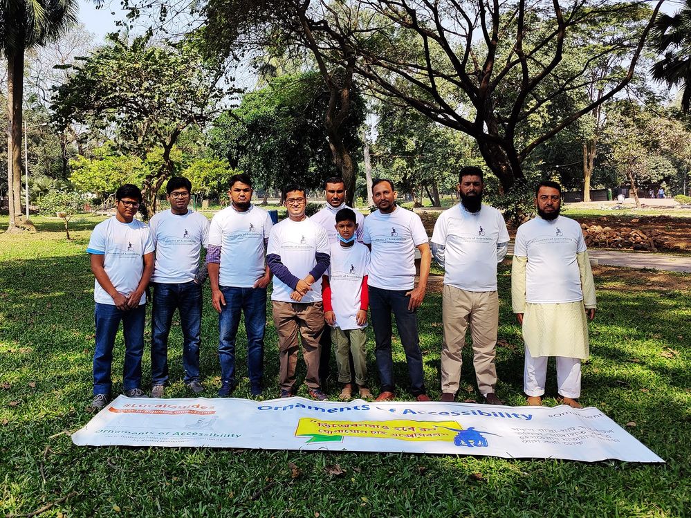 Caption: Local guides group photo standing with a lying banner.