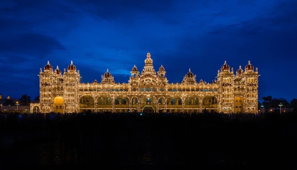 Caption: A photo of the Mysore Palace lit up at night. (Local Guide @jayasimha78)
