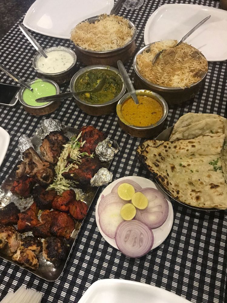 Caption: Lunch at Shadab Hotel: mutton biryani, garlic-butter naan, kebab platter, tandoori chicken, palak paneer, plus raita and mirchi ka salan on the side