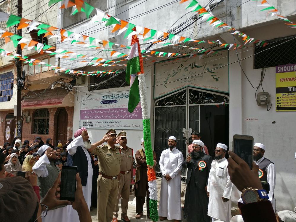 Police Officers, Principal and students pay homage to our National Flag