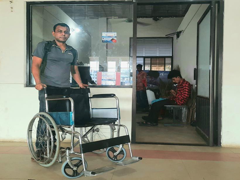 Caption: A photo of Mukul holding a wheelchair during his meet-up at the Dhaka River Port in August 2021. (Courtesy of Local Guide @MukulR)