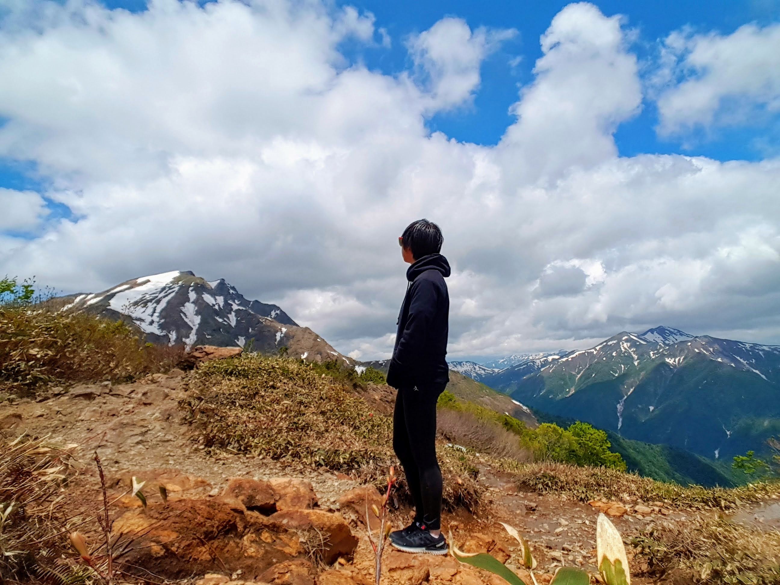 A photo of me looking at mountains partly covered with snow, Mount Tanigawa, Gunma, Japan