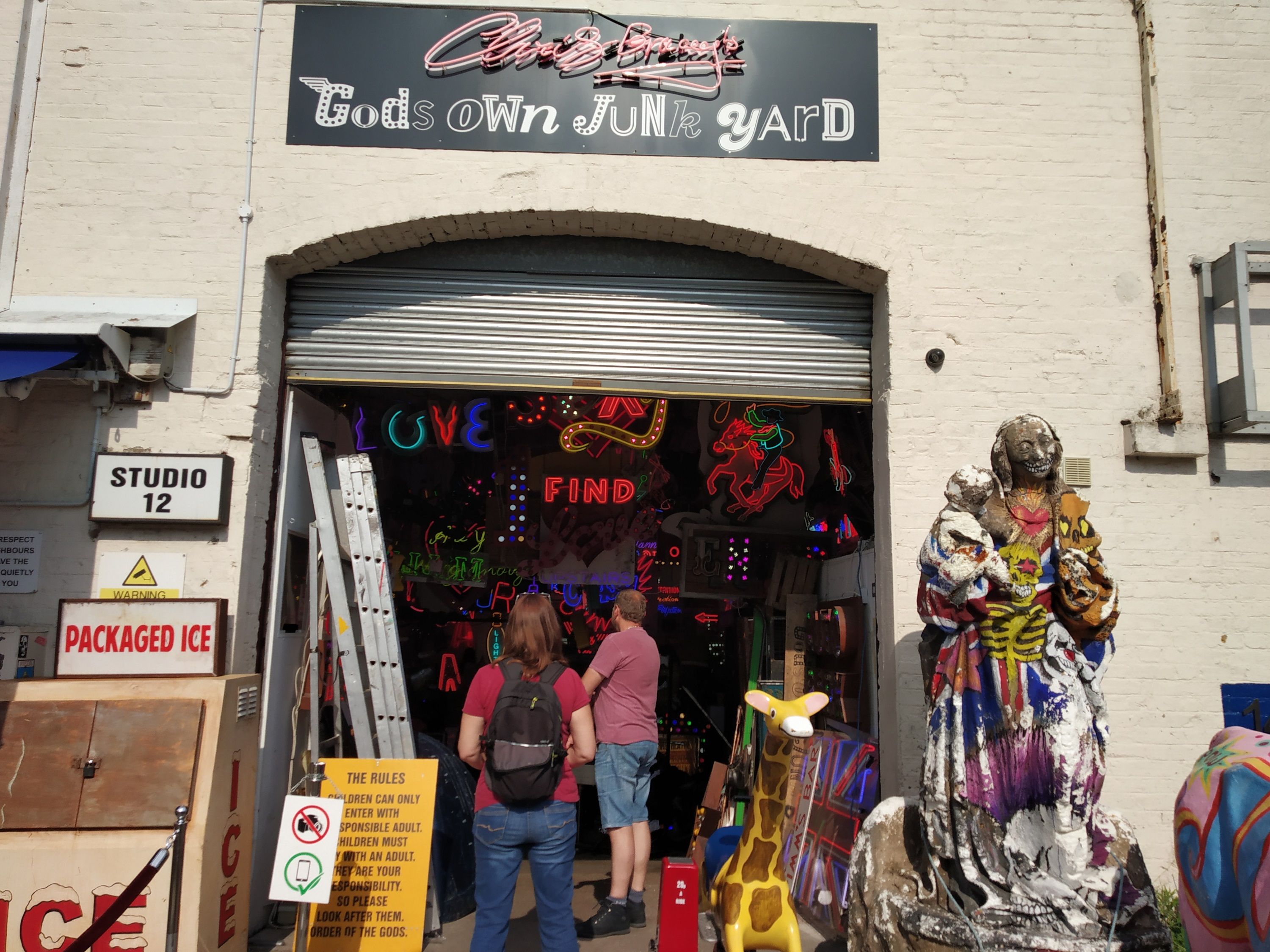 Caption: A photo of the front door of an art gallery filled with neon art called God's Own Junkyard in London, United Kingdom. (Local Guide @Explore_Keshav)