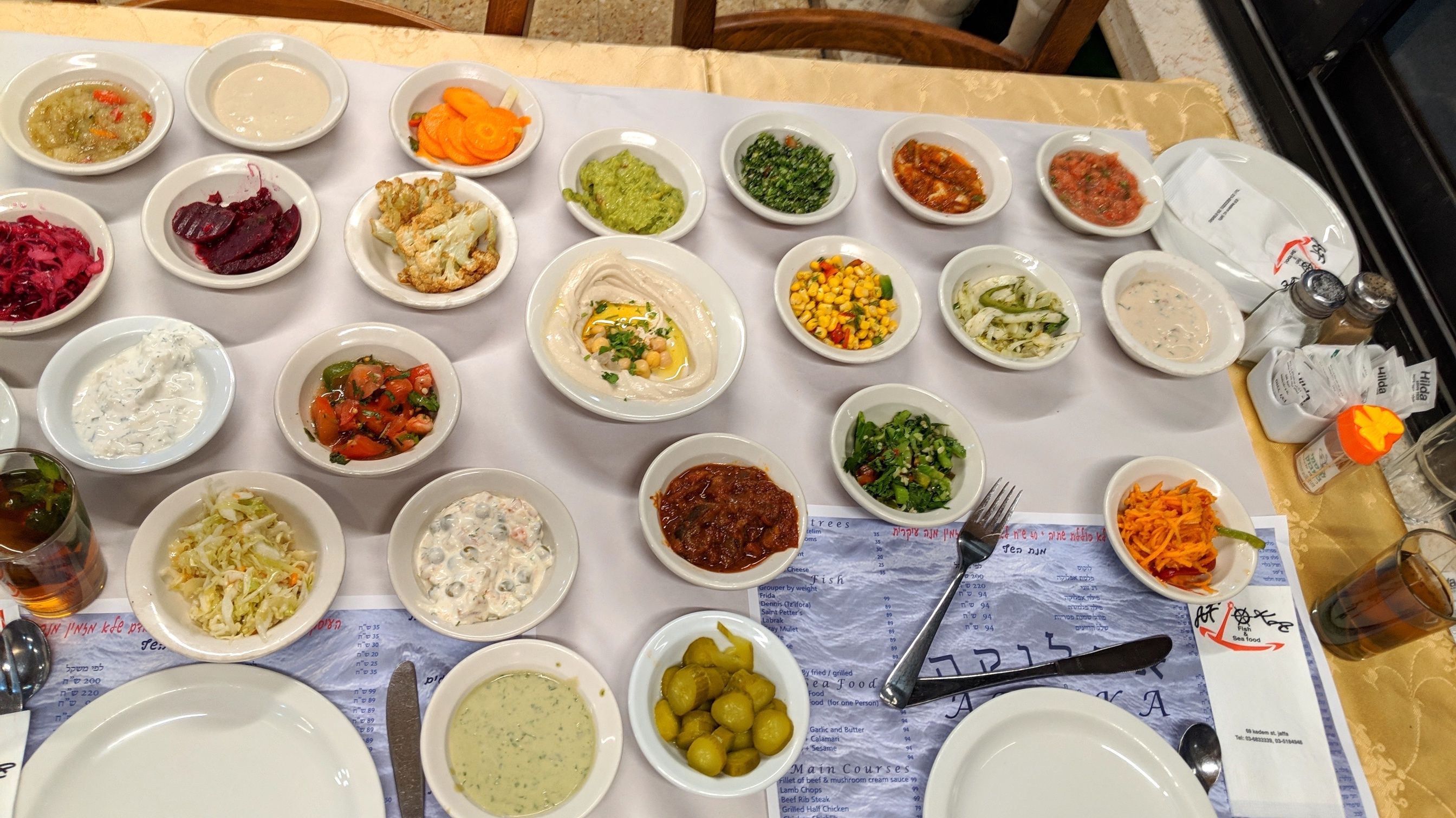 25 fresh delicious salads served with every meal in certain restaurants in Israel as part of the meal