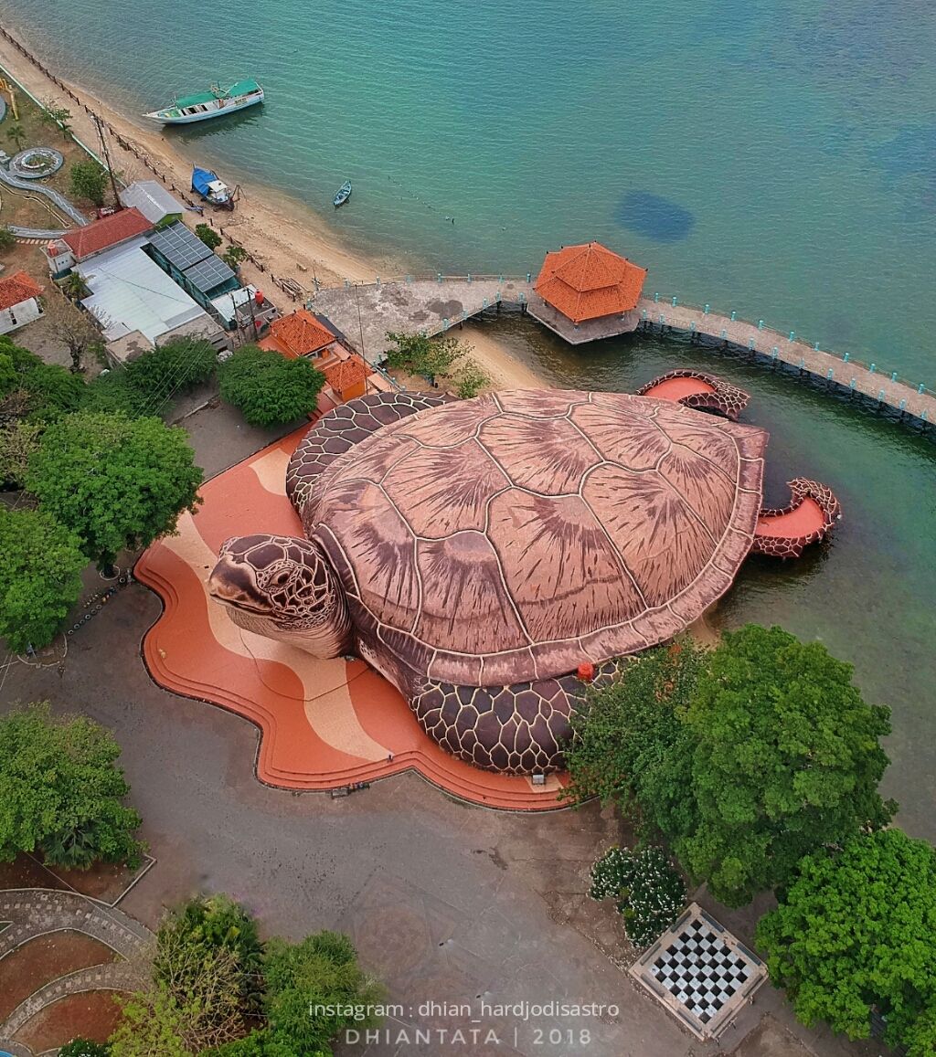 Caption: An aerial photo of the exterior of Kura Kura Ocean Park, a marine park and aquarium in Jepara, Indonesia shaped like a huge turtle. (Local Guide @dhiantata)