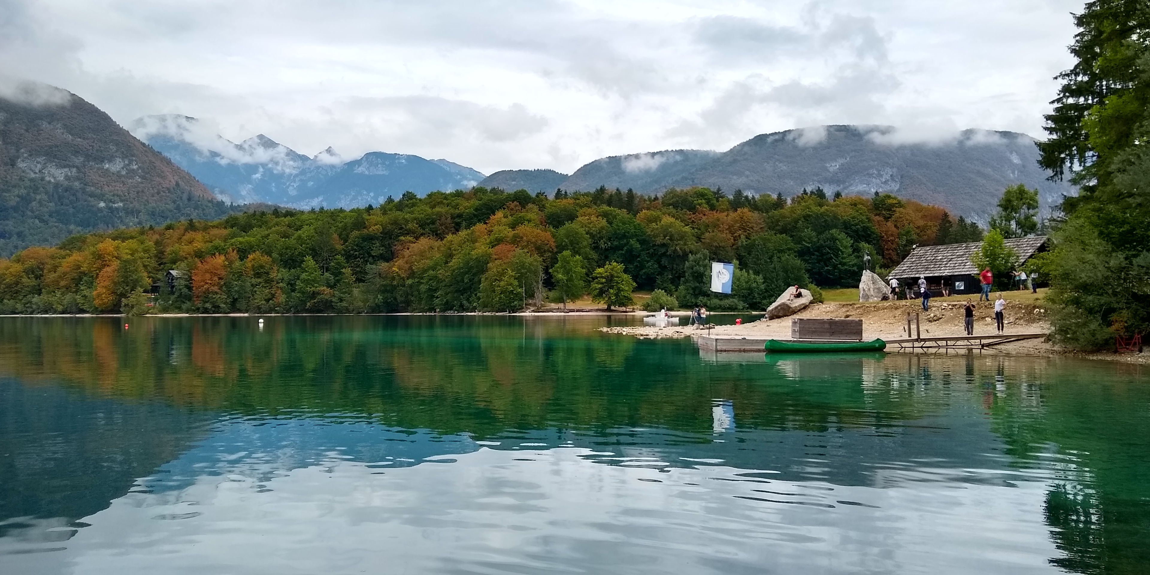 Caption: A photo of a landscape in Slovenia, taken on a cloudy day for across the water. (Local Guide @vvbellur)