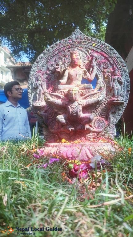 God Bishnu over his ride Garuda with  Our local Guide Saroj Dhakal