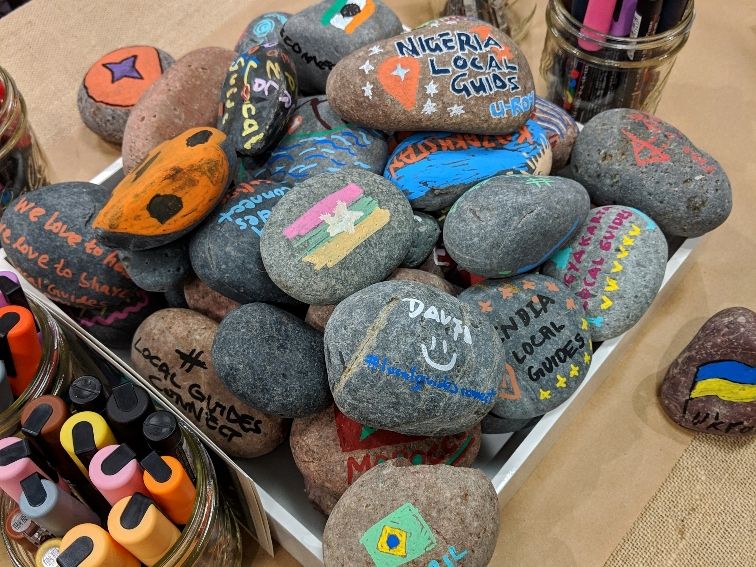 Caption: A photo of a box filled with colorful rocks that were designed by Local Guides during Connect Live 2018.