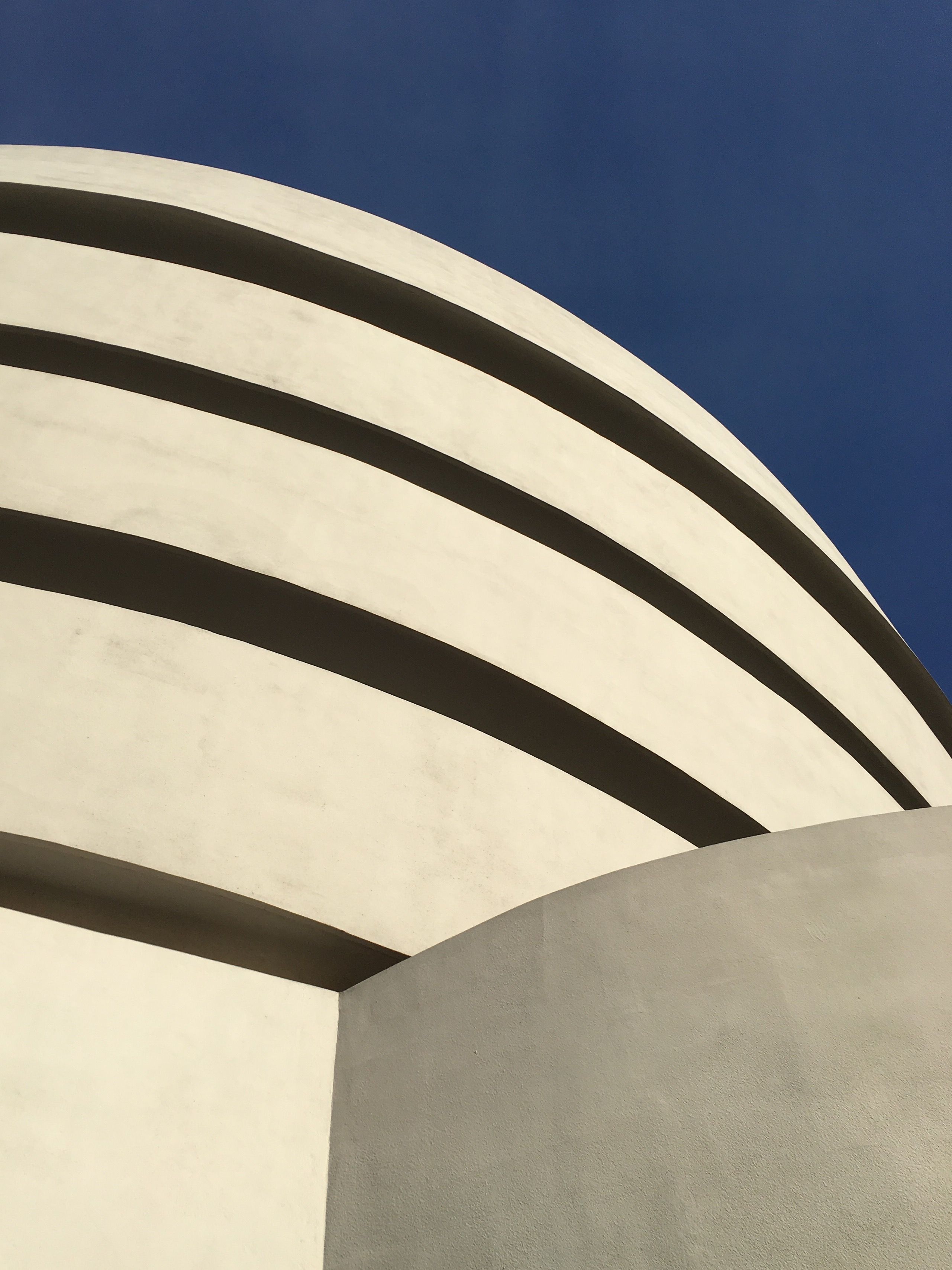 Caption: A close-up photo of the architectural lines on the Guggenheim Museum, located in New York, NY. (Local Guides Christina-NYC)