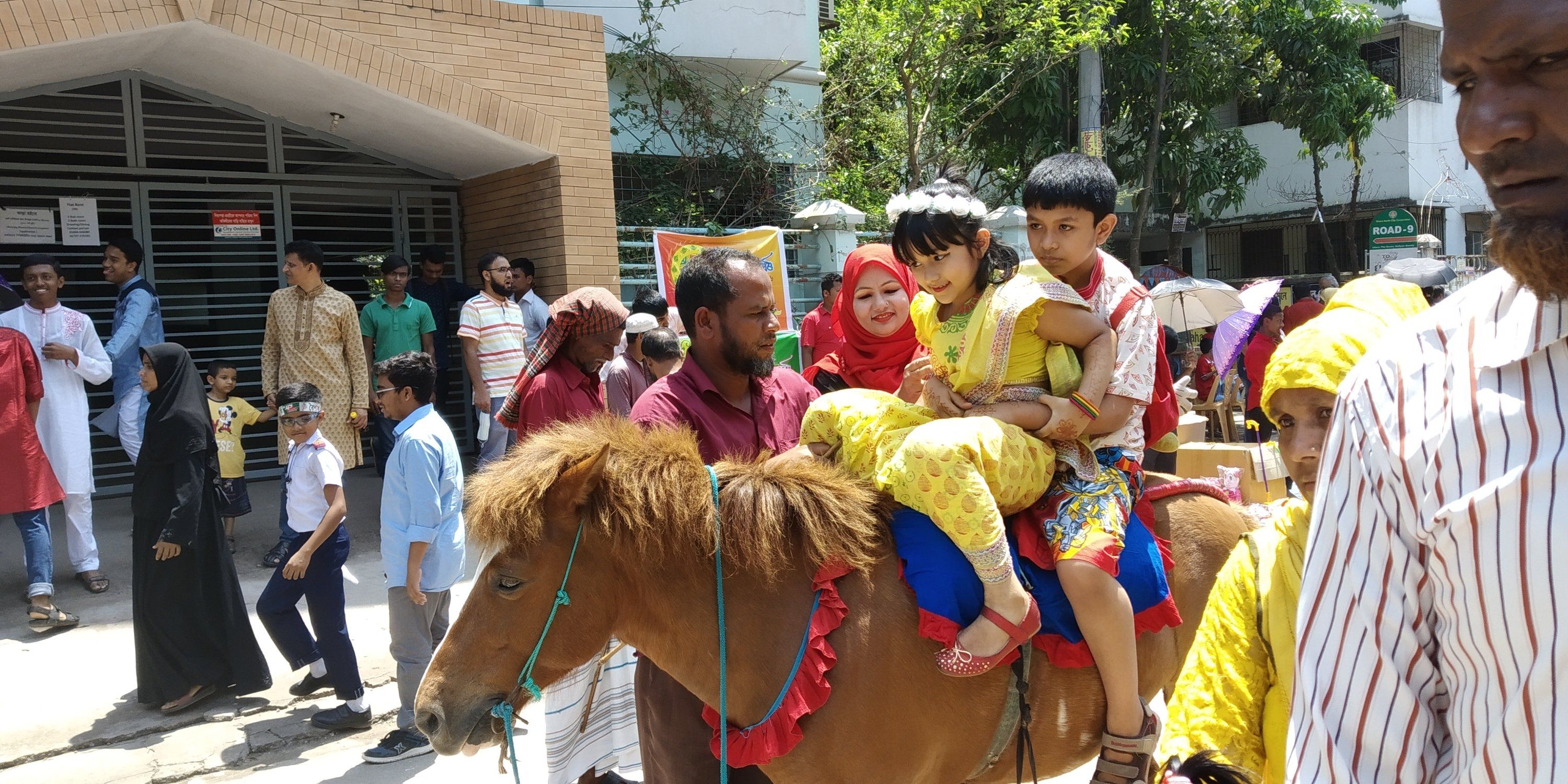 2 kids enjoyinging  Horse Ride in Baishakhi Fair
