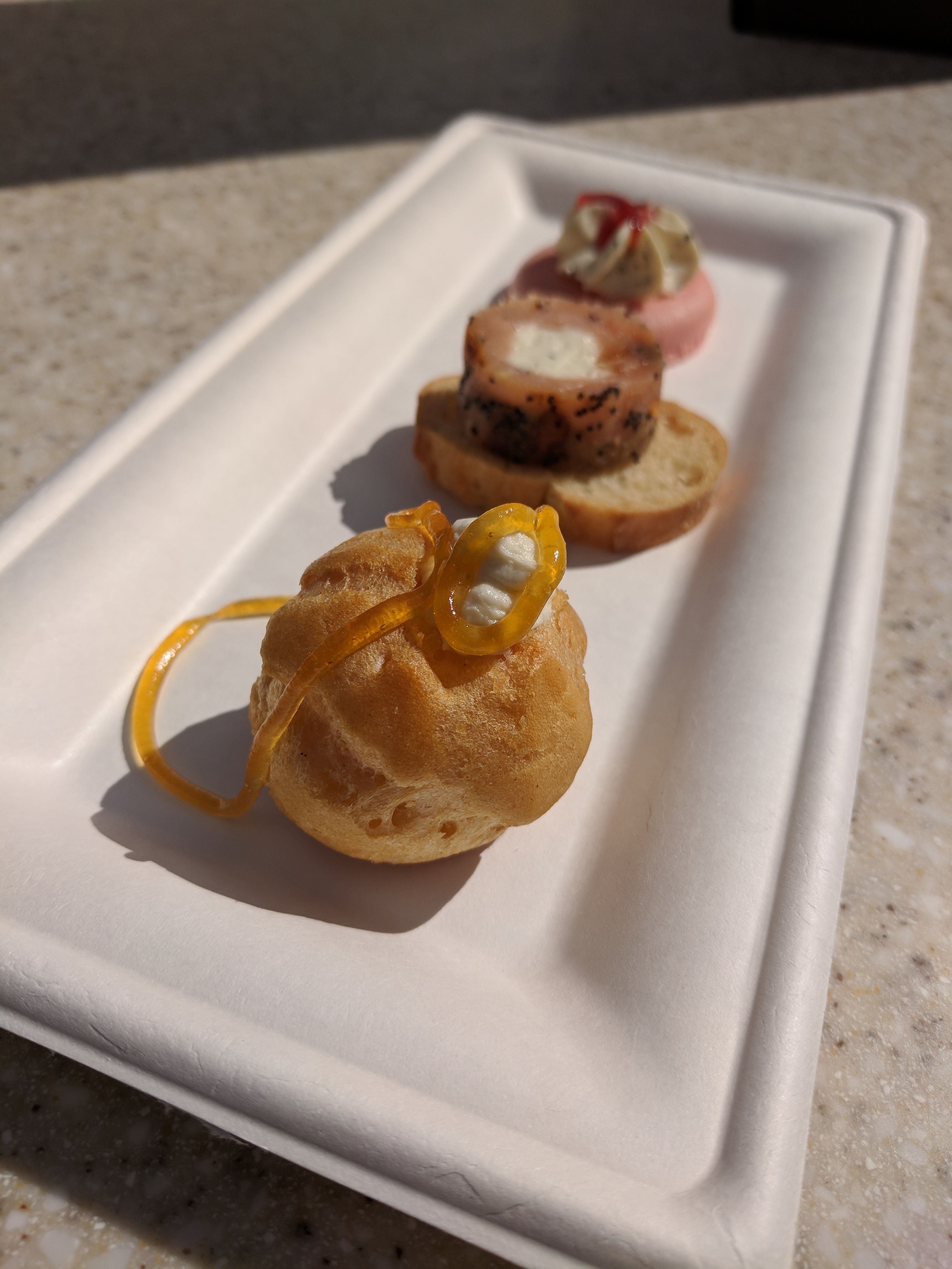 Cheese Studio: Cheese Trio: Profiterole topped with Boursin Garlic and Fine Herbs Cheese and Orange Apricot Jam; Smoked Salmon Pinwheel with Boursin Shallot and Chive Cheese and Everything Seasoning; Strawberry Macaron with Boursin Pepper Cheese