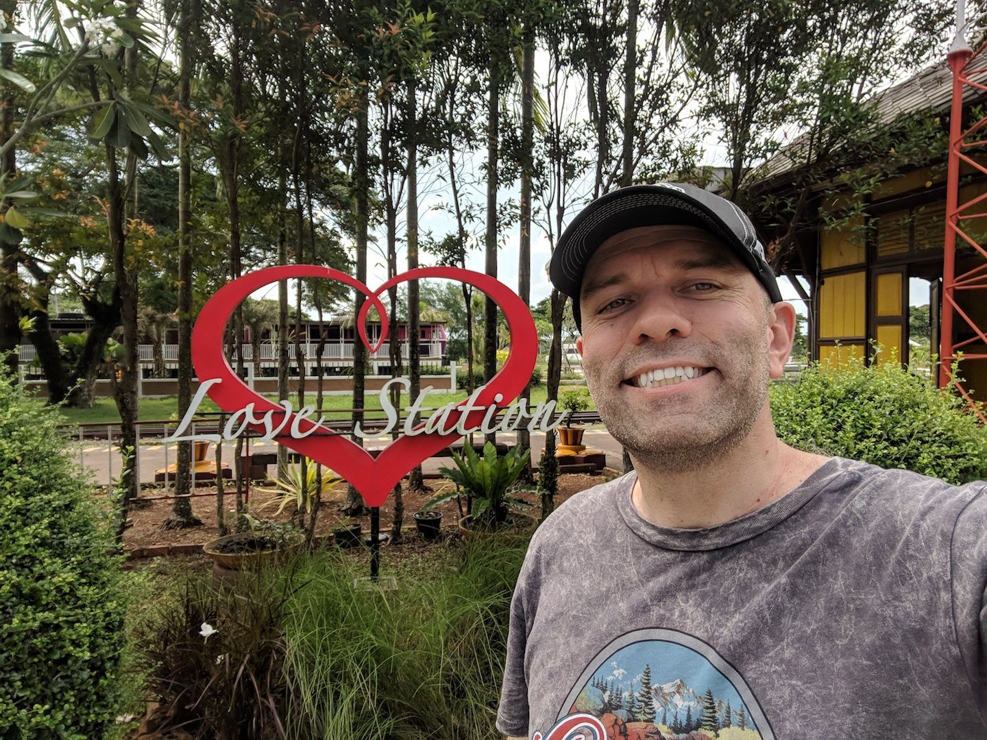 Caption: A photo of Local Guide Joseph Dewey smiling outside near a sign that says “Love Station.” (Local Guide @JosephDewey)