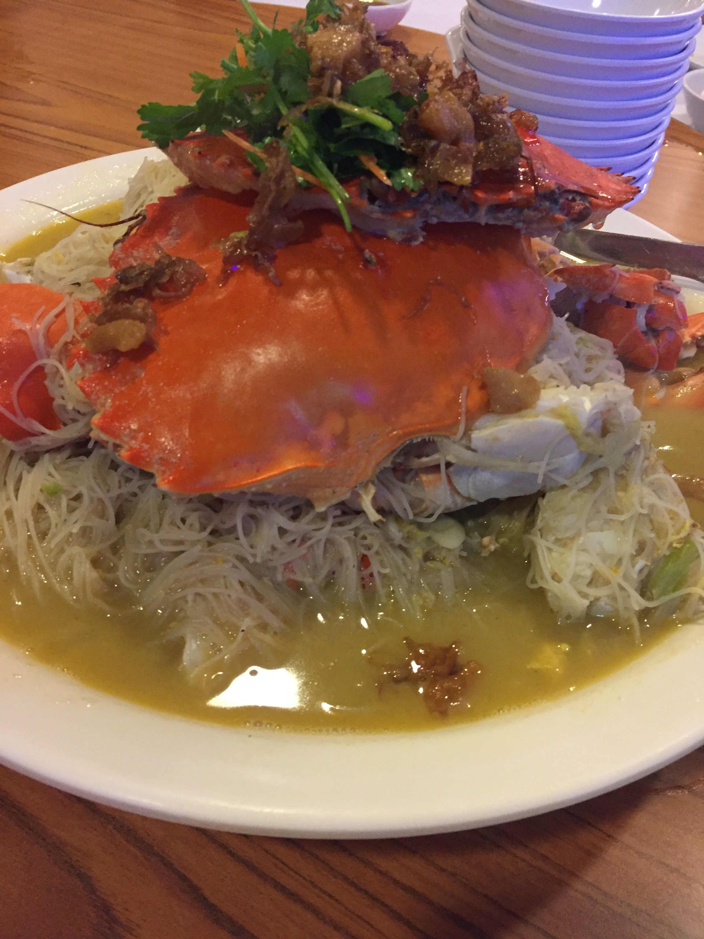 Caption: Crab dish, with rice noodle and seafood broth on a plate (Local Guide @AngieYC)
