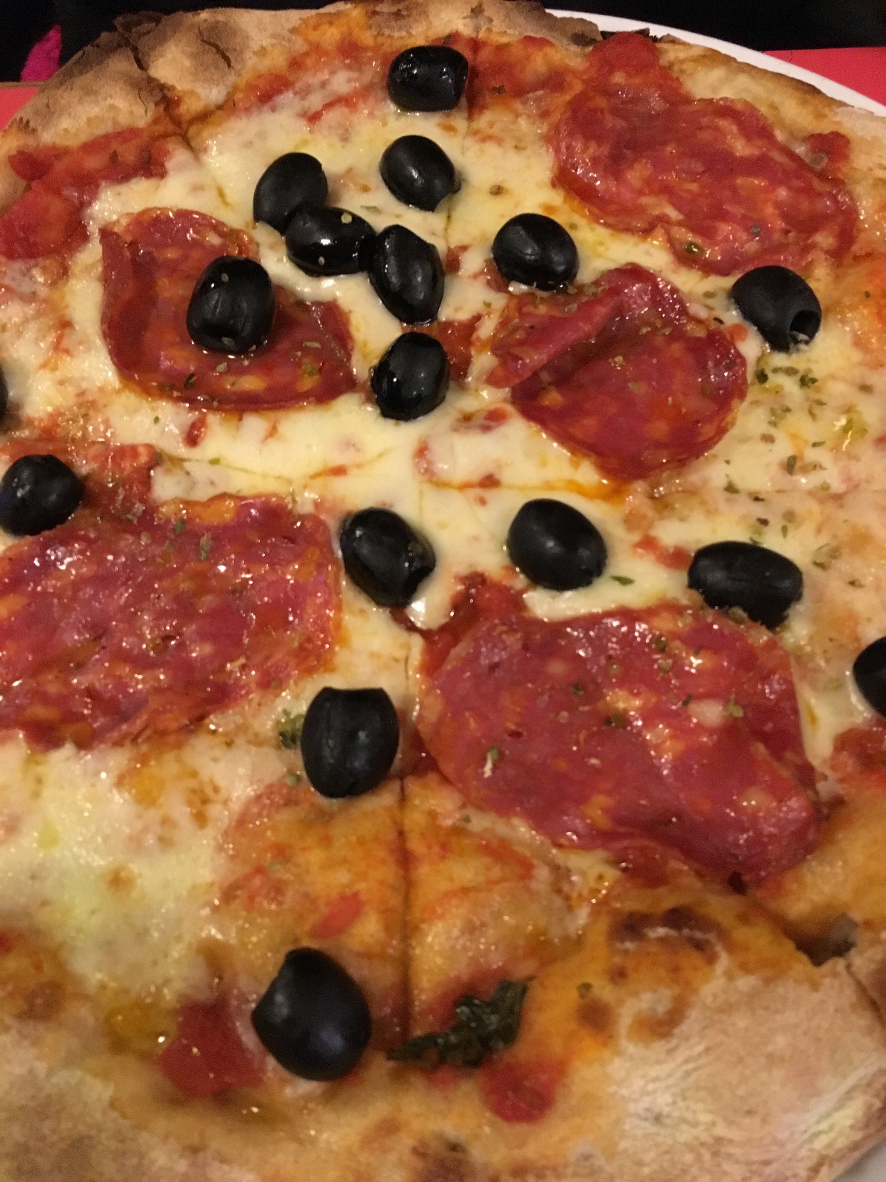 Caption: A closeup of Pepperoni Pizza, with salami, olives and mozzarella (Local Guide MashaPS)
