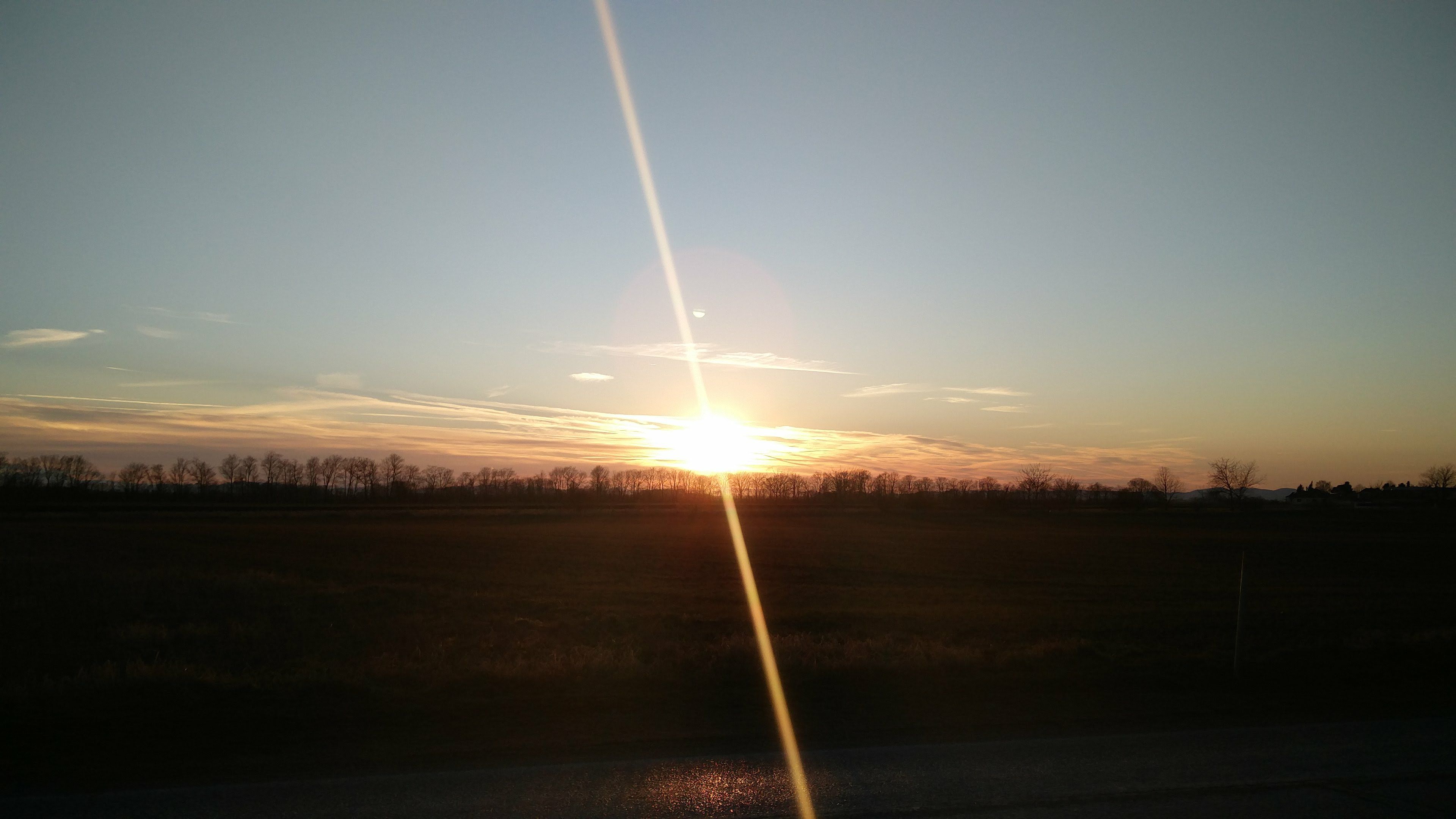 Vertical sunray through the field of sunrise