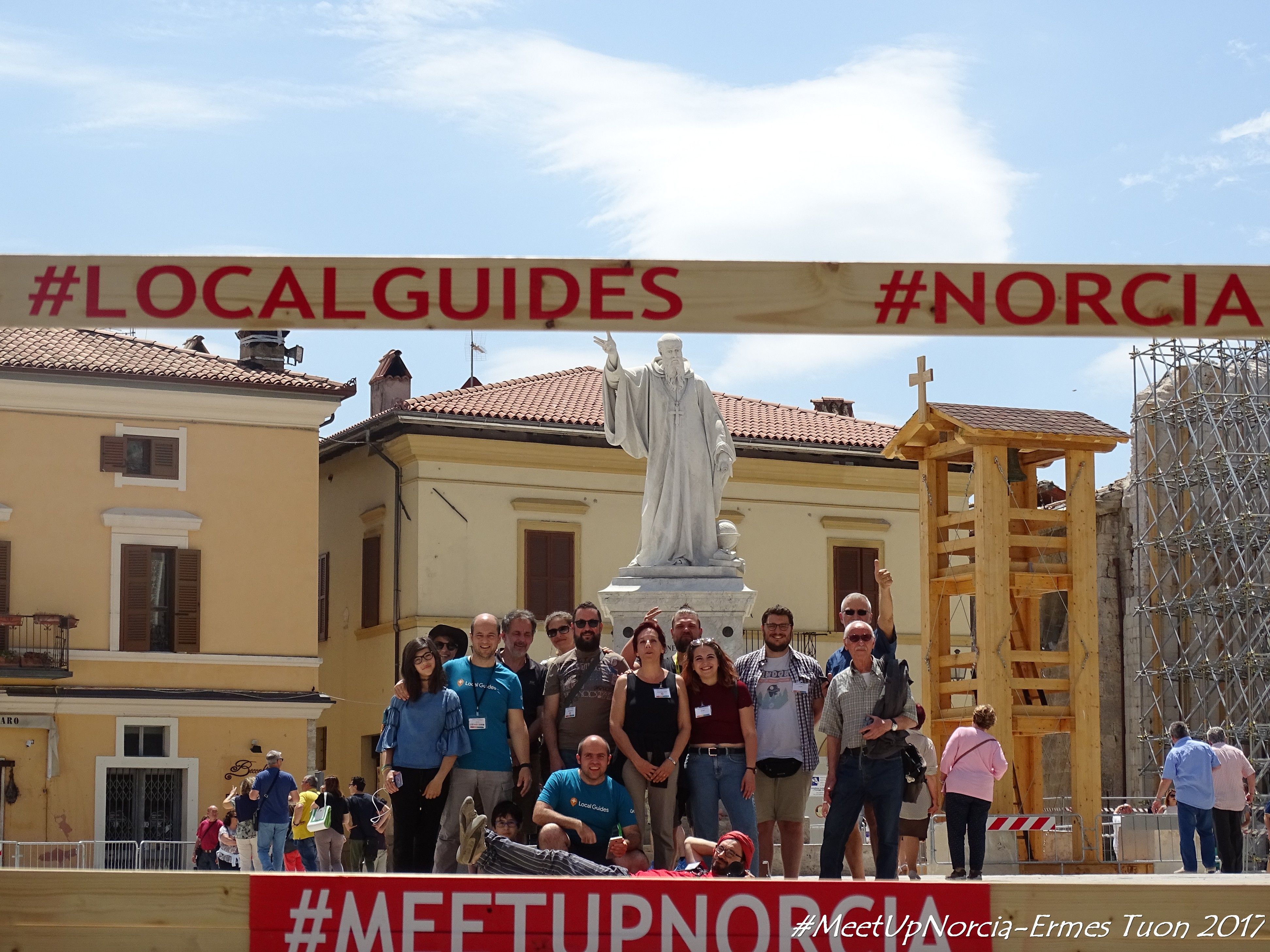 Caption: A group of Italian Local Guides in Norcia, with the Statue of St. Benedict on the background