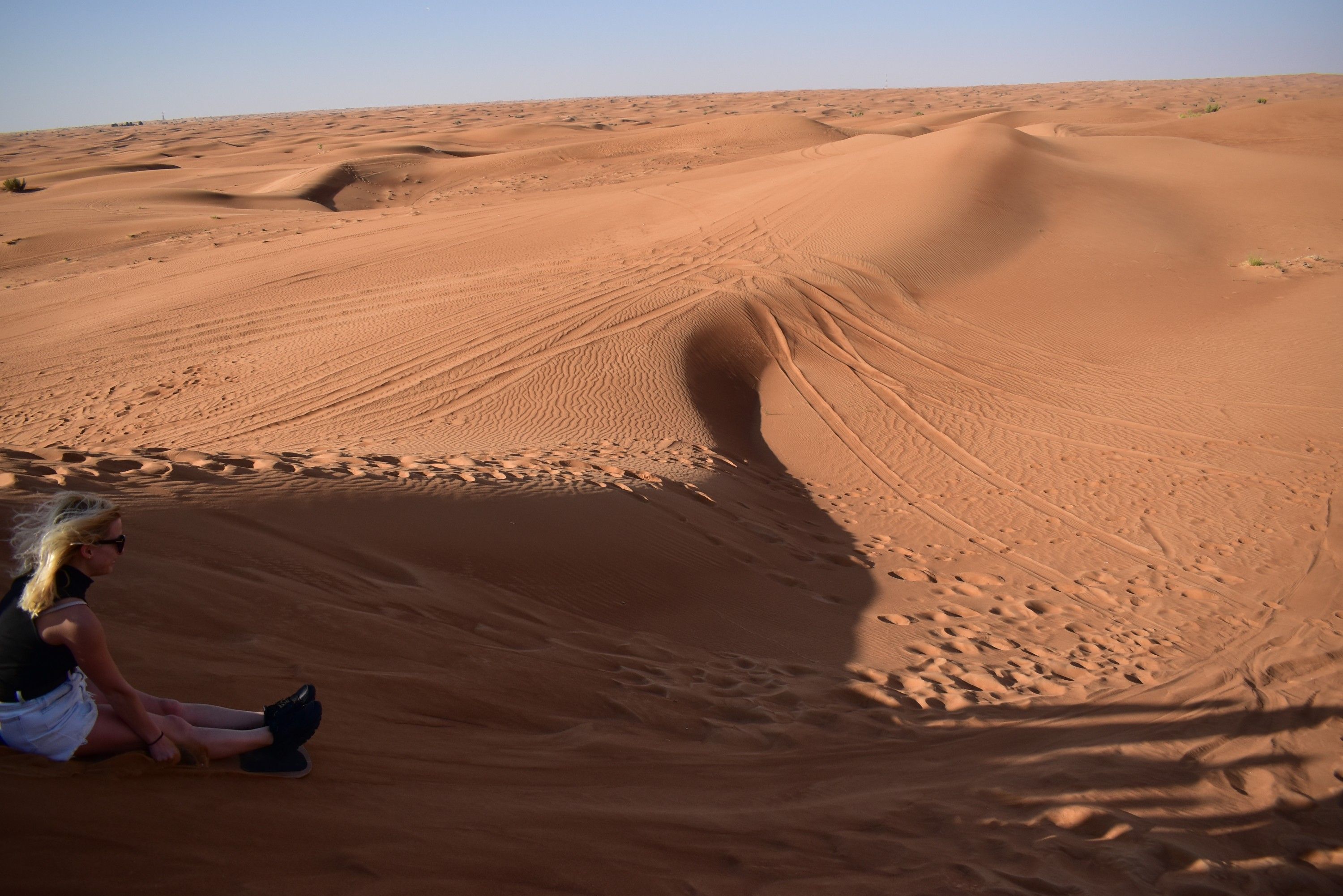 Caption: A photo of Local Guide @MoniDi doing sand sledding in the desert (A friend took the photo)
