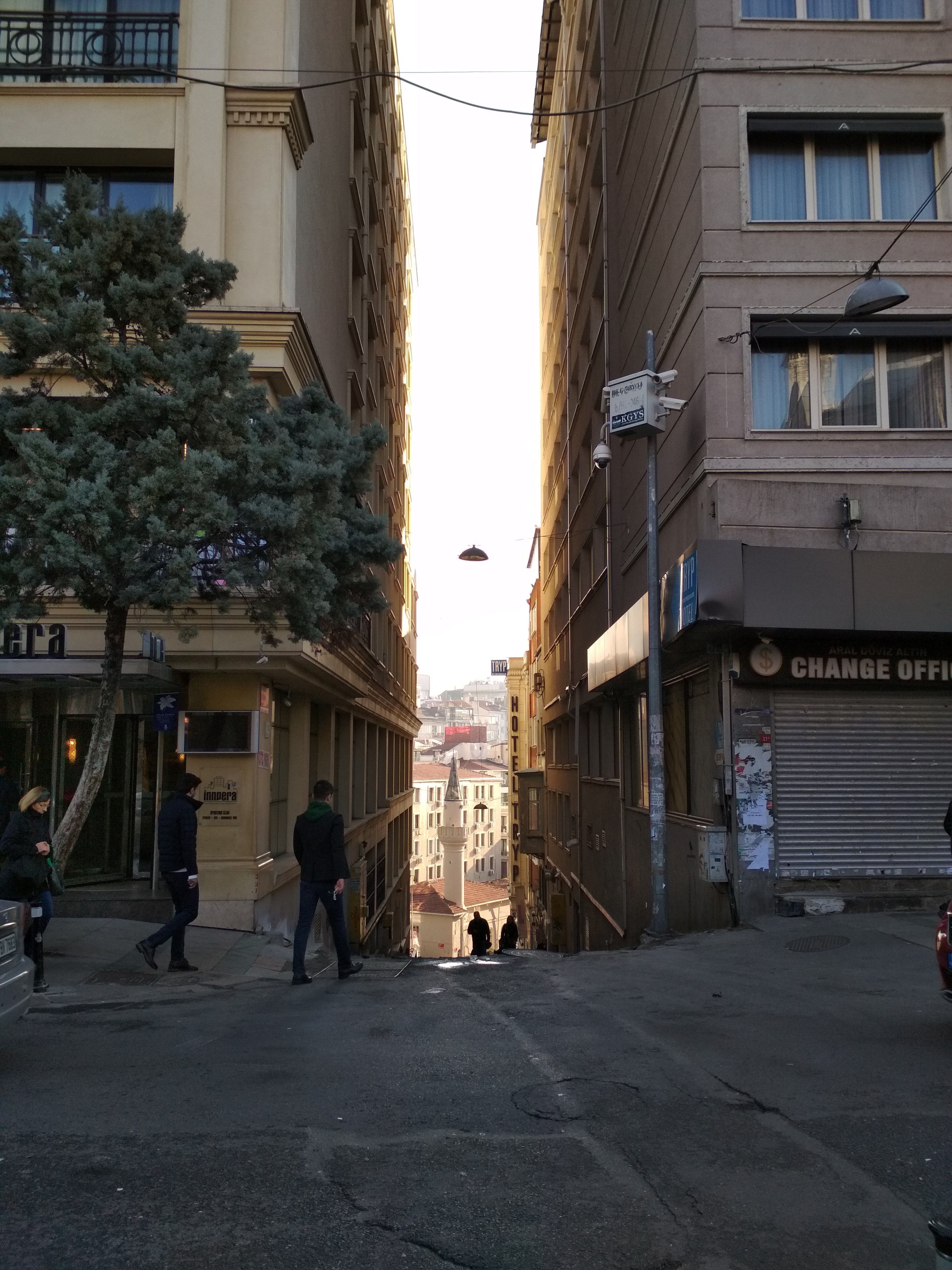 Caption: A photo of two building in Istanbul, Turkey, forming a narrow space, brightly lit by sunlight. (Local Guide @DeniGu)
