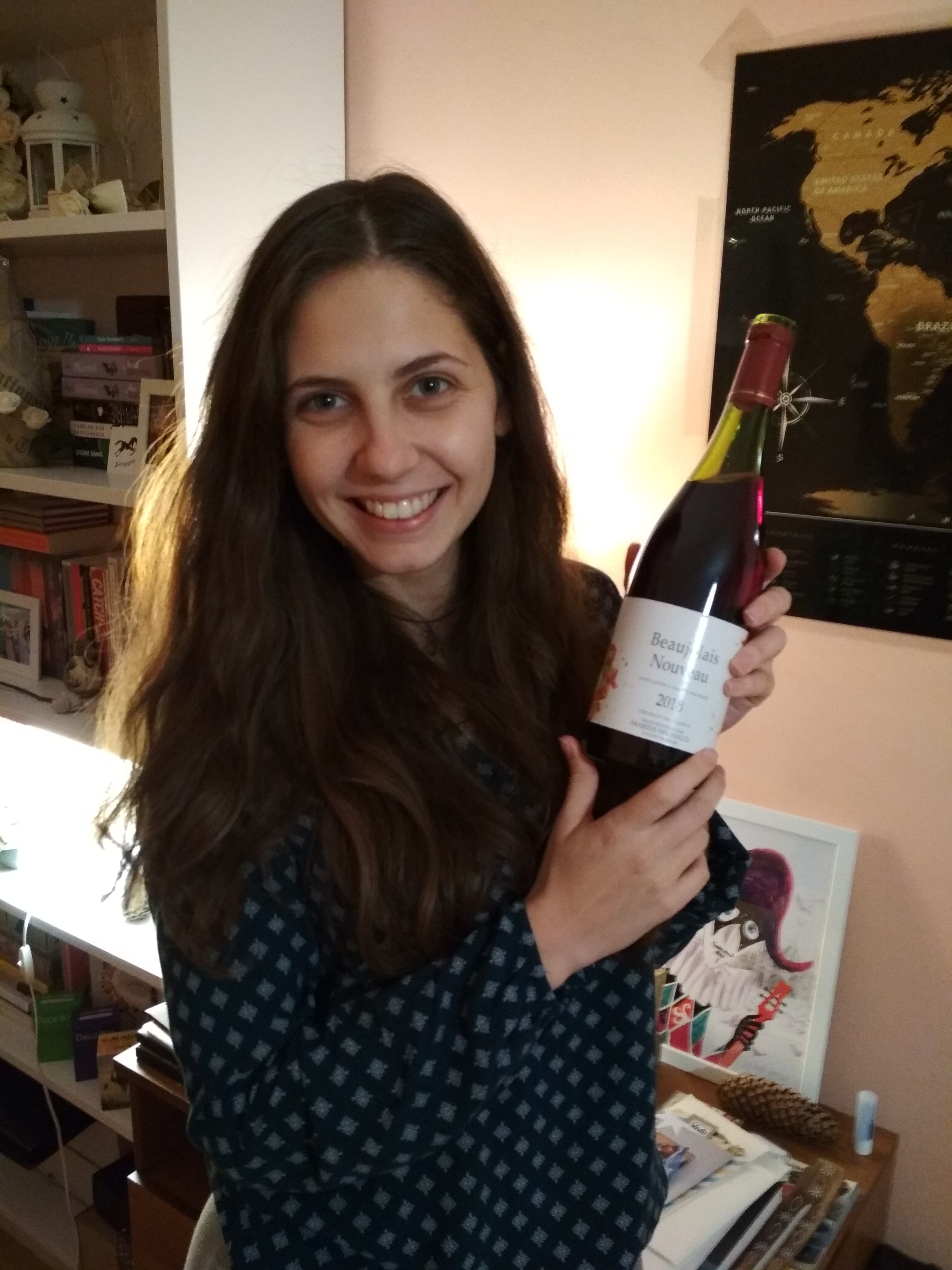Caption: A photo of Google Moderator @DeniGu, holding a bottle of red Beaujolais Nouveau wine. (Local Guide Ivaylo Mihov)