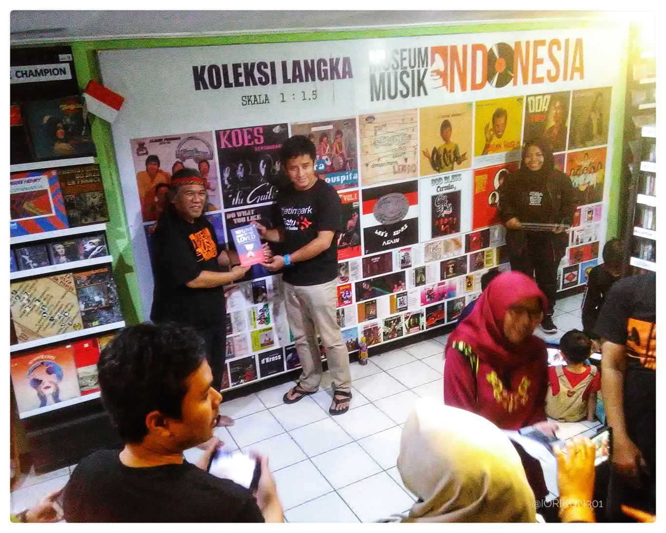 Mr. Hengky (left), Museum Musik Indonesia's Director, giving us a book as souvenir