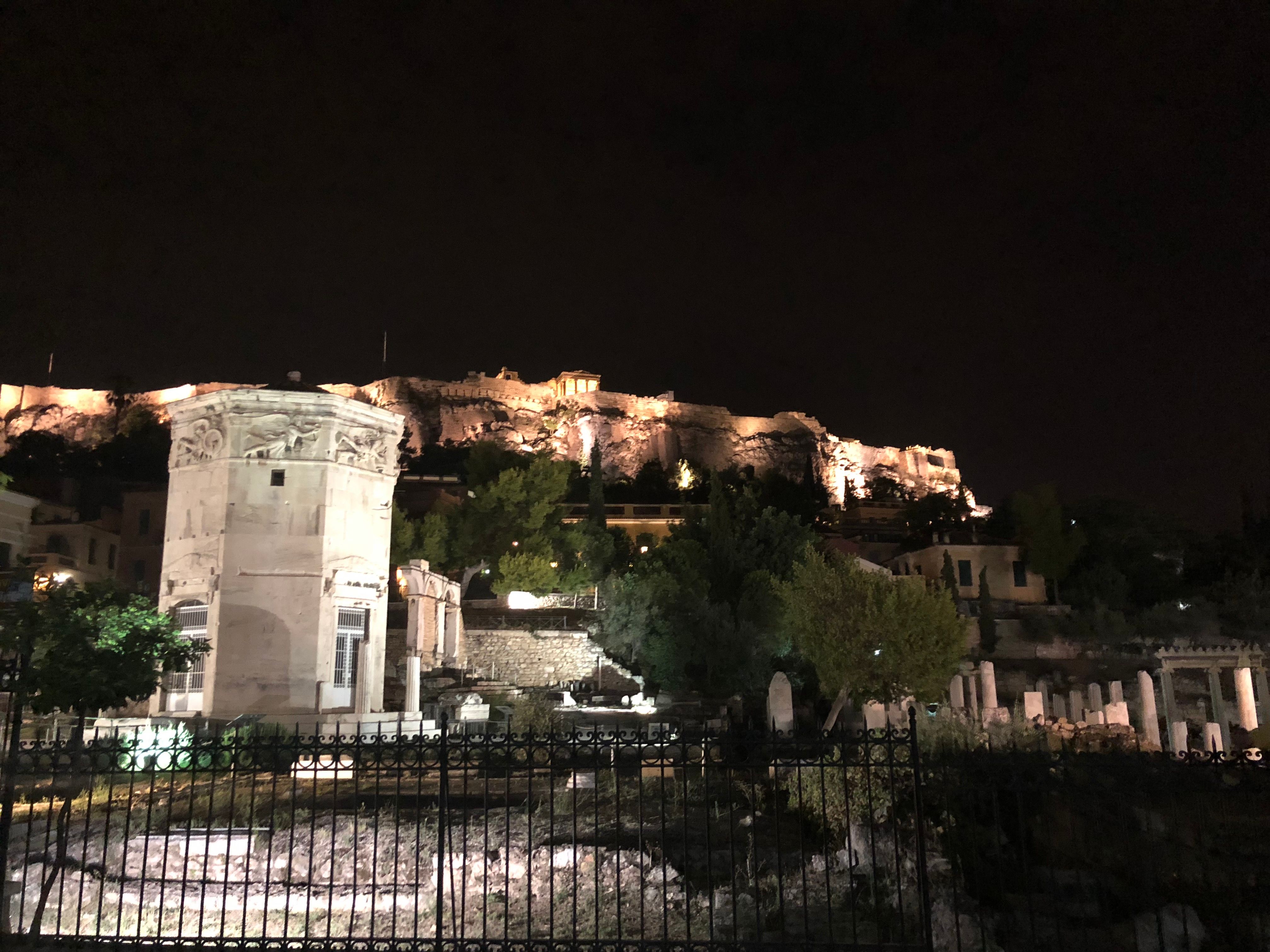Caption: photo taken during the night from the outside of Acropolis of Athens, on the left a very ancient o'clock with the Parthenon (Local Guide @FelipePk).