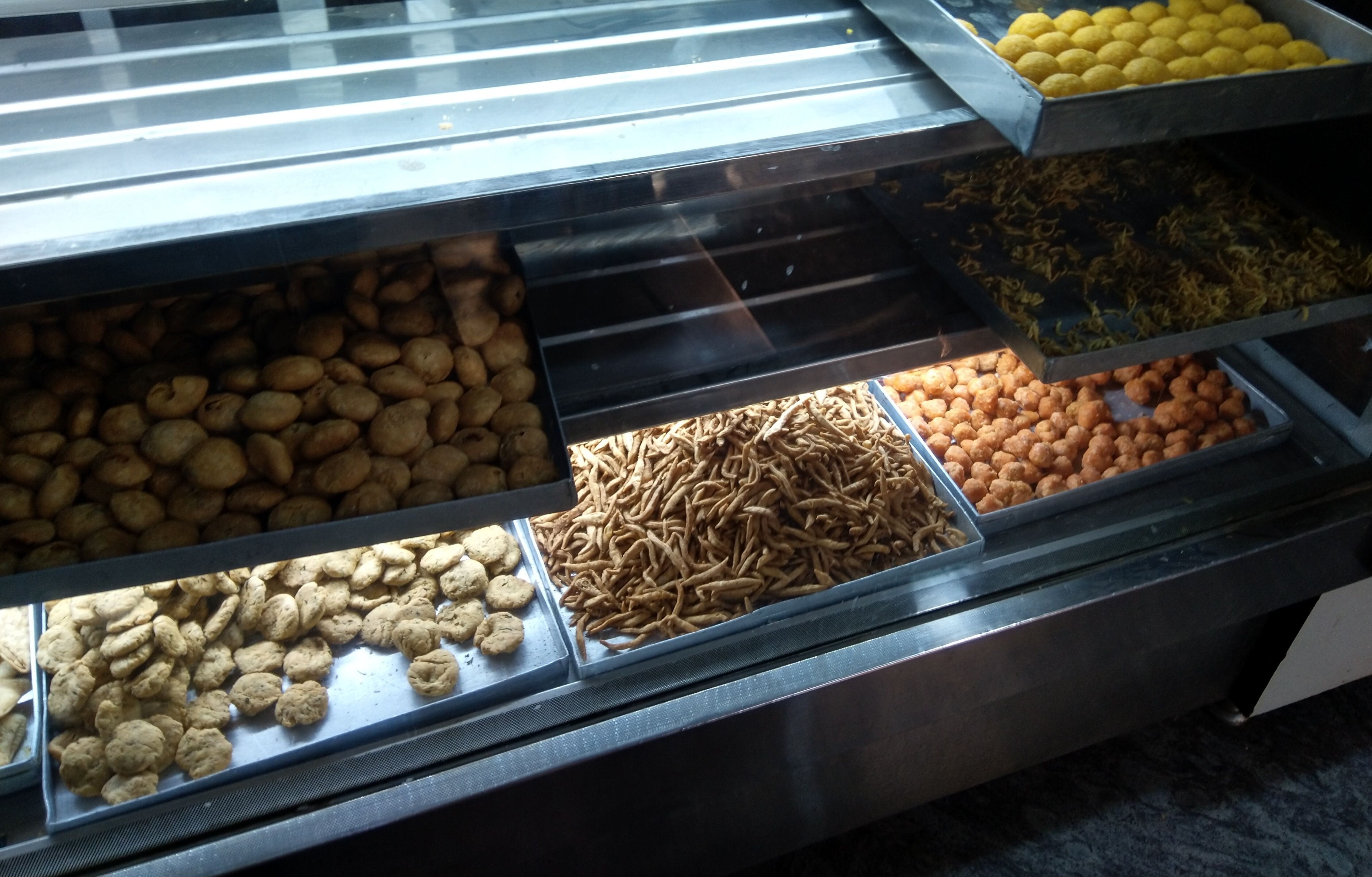 This snacks available at the local store. People in India like to have them in the evening with tea. These are Matthias, namakparas, shakkarparas, laddoos, kachori in the local languages.