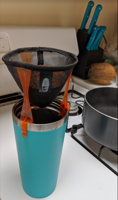 A photo of a portable coffee maker in use.