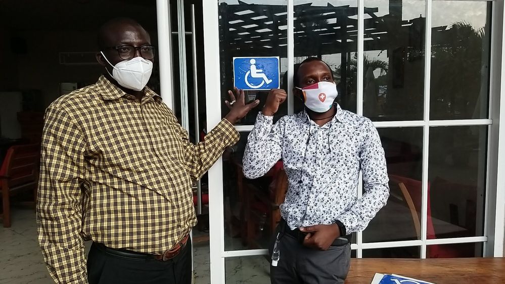 Caption:  Magistrate Muhammed Krubally and myself posing after sticking an accessibility sticker at Dragon Red Restaurant
