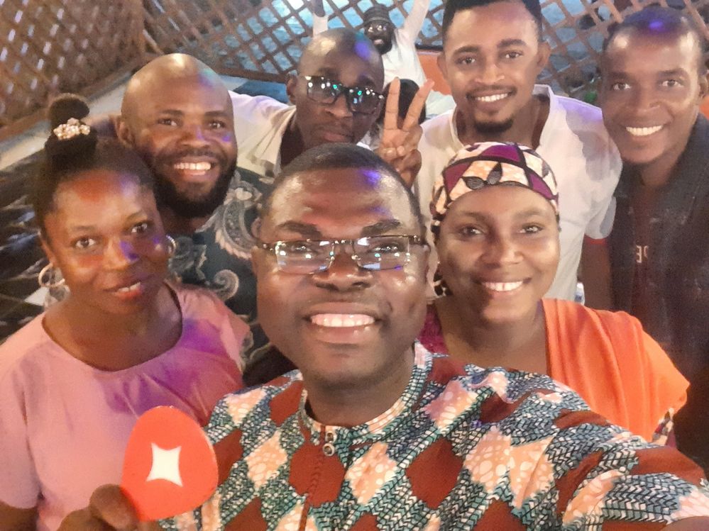 Caption: A selfie of a few local guides during the BLDG VI Abuja Suya Crawl smiling happily at the cameras after a successful night together. @Shola_ the host holding up a connect local guides pin.