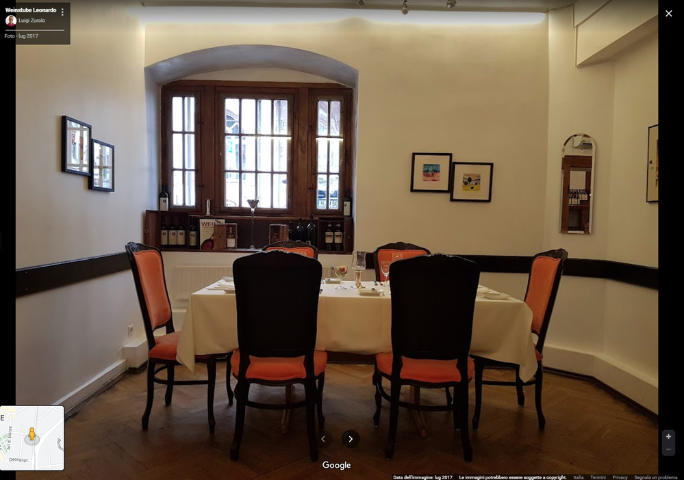 Caption: photo of a table with chairs prepared for dinner inside an Italian restaurant in Hannover, Germany. Local Guide @LuigiZ