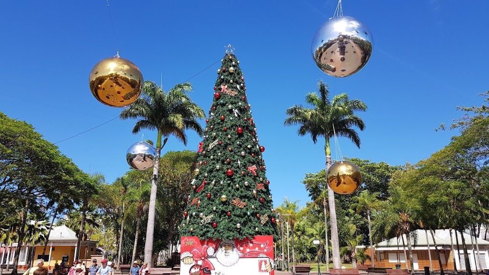 Caption: A photo of a decorated Christmas tree and giant baubles hanging in the air in Nouméa, New Caledonia. (Local Guide PJ L)
